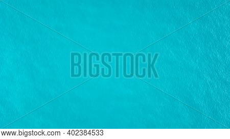 Top View Of The Turquoise Water. Like A Background. Small Waves Create Ripples On The Sea And Change