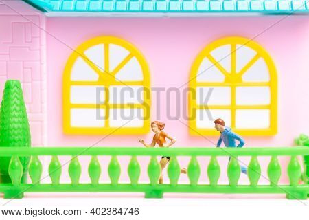 Miniature People , Couple Running Near Their House Together