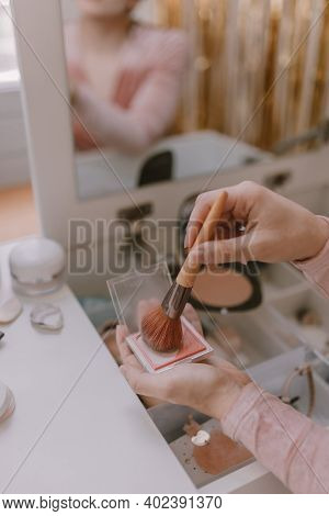 Young Millennial Woman Is Dressing Up. Wearing Earrings. Beauty Routine. Make Up Artist. Mascara, Li