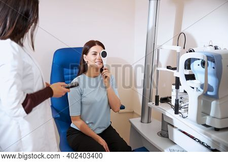 Lady Using An Occluder While Checking Her Eyesight