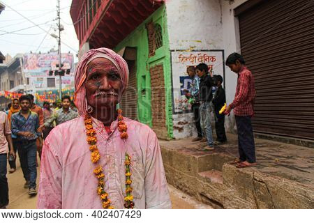 Mathura, Uttar Pradesh/ India- January 6 2020: Portrait Of An Old Man Celebrating Holi With Flowers 