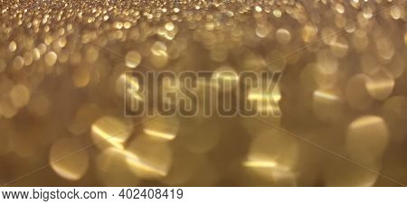 Closeup Of Sparkling Golden Bokeh Glitter Abstract