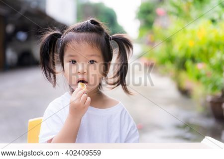 Girl Was Forced To Eat Fruit. Cute Child Eating Oranges In Front Of Her House. Parents Are Forced To