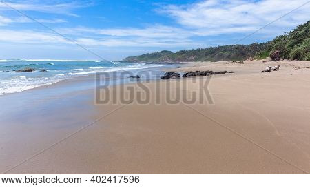 Scenic Empty Beach Ocean Sea Waves Shoreline Sand Rocks Coastline Vegetation Trees Panoramic Walking