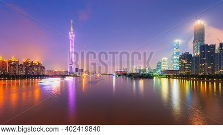 Guangzhou, China skyline on the Pearl River at dusk.