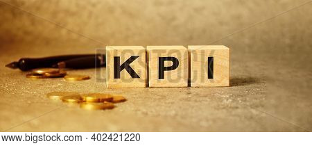 The Inscription Kpi On The Texture Of Wooden Cubes On The Background Of Manet. An Inscription On A F