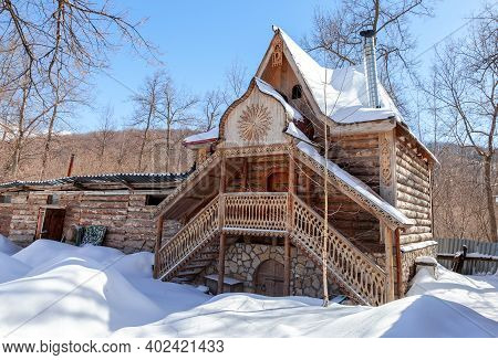 Traditional Vintage Russian Timber House. Facade Of An Old House Decorated With Wooden Carvings, Pla