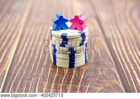Gender Pay Equality Concept. Blue Doll Representing A Man And Pink Doll Representing A Woman On A St