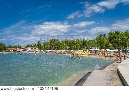 Zaton, Croatia, July 2019 People Relaxing On Beautiful Zaton Holiday Resort Beach. Families Having F