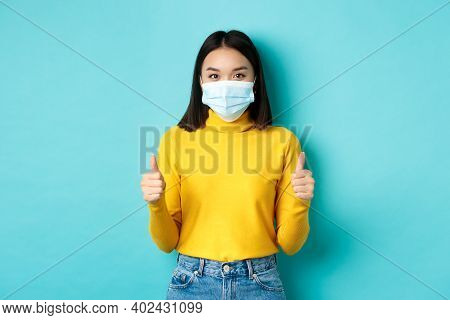 Covid-19, Social Distancing And Pandemic Concept. Supportive Asian Woman Recommend Promotion, Wearin