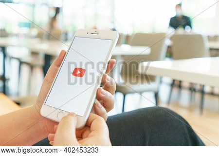 Chiang Mai, Thailand - Sep. 26,2020: Woman Holding Iphone 8plus With Youtube Apps On Screen. Iphone 