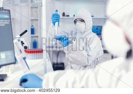 Healthcare Doctor Taking Sample From Test Tube Using Micropipette. Team Of Microbiologists In Resear