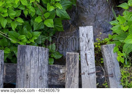 Small Wooden Bridge Over A Small Strem Water  In A Rural Village In Northern Thailand.
