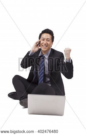 Young Business Man Using Laptop And Phono High Quality Photo