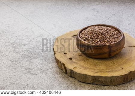 Flax Seeds In A Wooden Bowl On A Concrete Background, A Dietary Cereal Ingredient For Granola That R