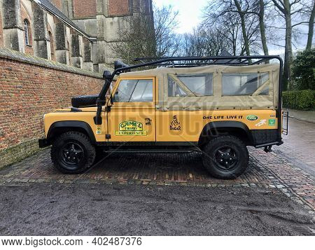 Veere, The Netherlands - Januari 2, 2021: Yellow Land Rover Parked On A Public Parking Lot. Nobody I