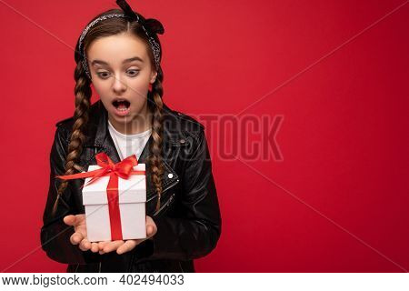 Photo Of Beautiful Happy Amazed Brunette Girl Isolated Over Red Background Wall Wearing White Casual