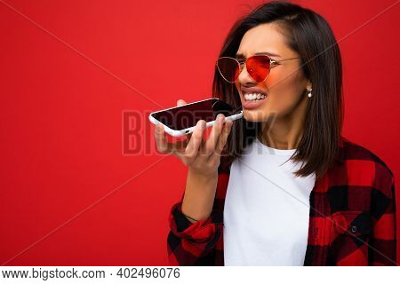 Photo Of Beautiful Angry Young Brunet Woman Wearing Stylish Red Shirt White T-shirt And Red Sunglass