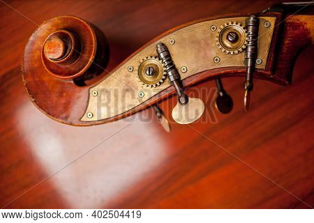 Violin On Wooden Background. Violin And Bow On A Dark Wooden Table. Violin In Vintage Style On Wood 
