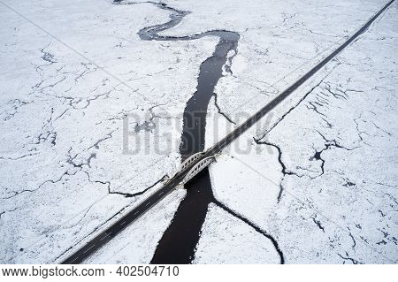 Aerial View Of A82 Road Through Rannoch Moor And Black Mount Covered In Snow During Winter