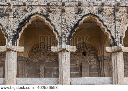 Hampi, Karnataka, India - November 5, 2013: Zanana Enclosure. Detail Of Gray Stone Facade With Peaco