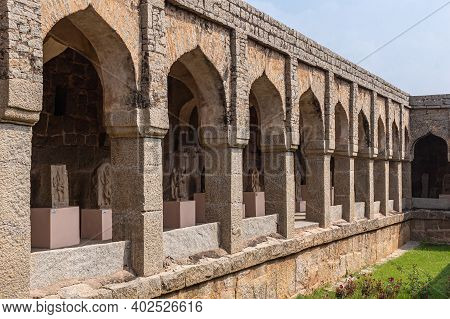Hampi, Karnataka, India - November 5, 2013: Zanana Enclosure. Corner Of Gray-brown Stone Facade With