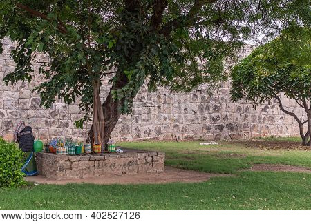 Hampi, Karnataka, India - November 5, 2013: Zanana Enclosure. Female Worker Guards Lunch Bags Of Her