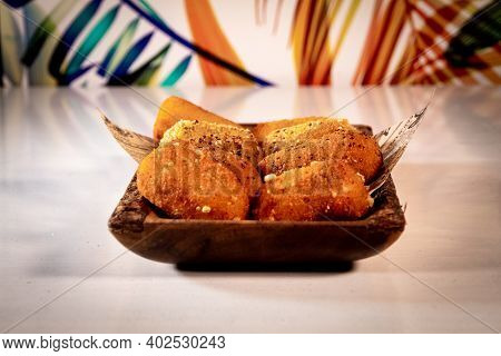 A Traditional Spanish Food Of Croquettes, Presented On A Tray With Letter Paper.the Background Is Fu