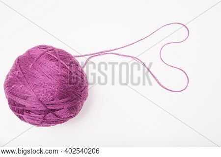 A Ball Of Purple Wool For Knitting, Crocheting Isolated On White, Violet Woolen Thread For Hobby And
