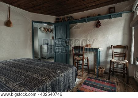 Traditional Interior Of Old Bedroom With Handmade Wooden Furniture And Traditional  Folk Ornament Te