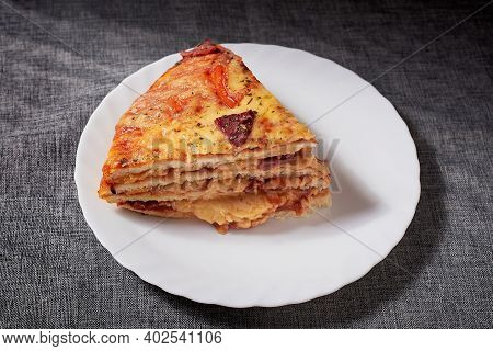 Italian Pizza Cake With Four Layers Full Of Grilled Salami, Ham And Moose Sausage. Black Background,