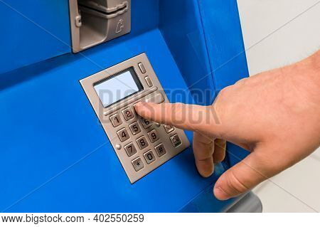A Man's Hand Dials A Pincode At The Terminal For Issuing Money, Close-up.