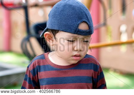 Asian Little Boy Portrait Tired Expression In The Park On The Playground For Kids & Children