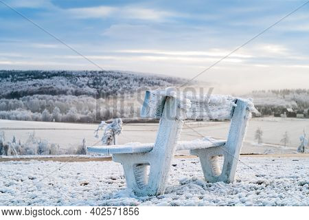 Winter Mountains Landscape And Wooden Iced Bench In The Morning
