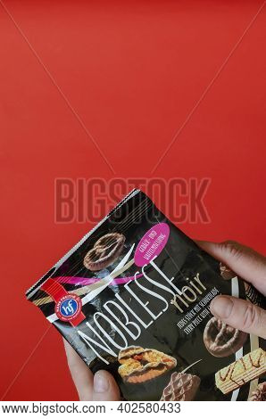 Hans Freitag's Noblesse Noir, Assortment Of Biscuits & Wafers Dark Chocolate In A Man's Hand - Ukrai