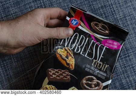 Hans Freitag's Noblesse Noir, Assortment Of Biscuits & Wafers Dark Chocolate In A Man's Hand - Ukrai