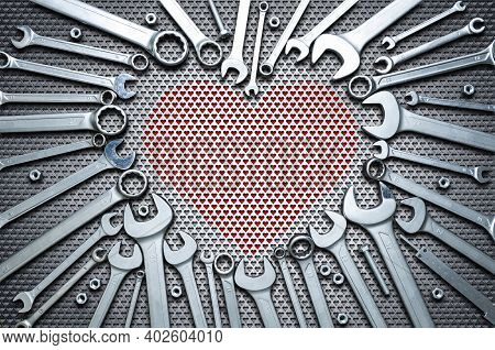 Concept - Professional Mens Holiday. Chrome Wrenches On A Steel Workbench In The Shape Of A Heart. C
