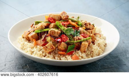 Vegetarian Meat Free Mycoprotein Pieces Vegetable Stir Fry, Brown Rice Served In White Plate