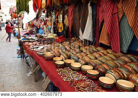 Pisac, Peru - September 04, 2016: Colourful Goods For Sale In Marketplace In Pisac, Peru On Septembe