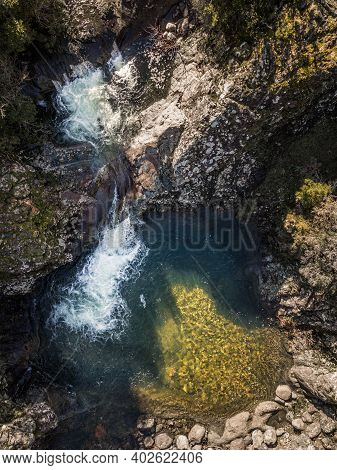 Mountain Stream Cascading Into A Rocky Pool In Corsica