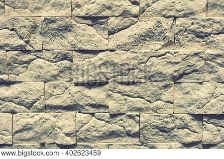 Stacked Stone Wall, Natural Stone Cladding. Stone Wall For Background. Wall Background Of Volcanic A