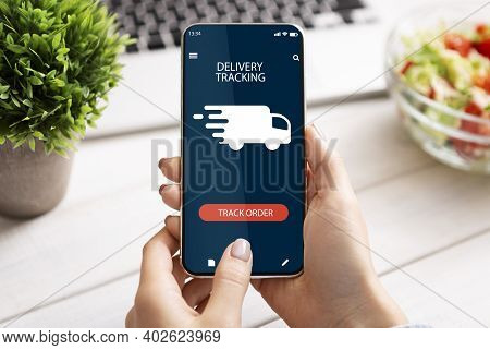 Track Your Order Online. Point Of View Of Young Woman Holding And Using Smartphone With Delivery Tra