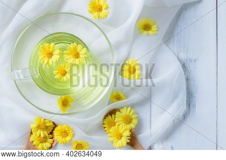 Hot Chrysanthemum In A Mug On A White Cloth And White Wood Background, Healthy Beverrage For Drink. 