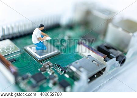 Miniature People Searching Or Checking For Bugs And Issue On Microchip, Mainboard Of Computer. Vulne