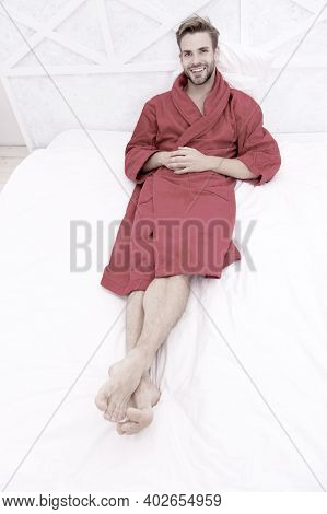 Guy In Bathrobe Relaxing. Maintaining Consistent Circadian Rhythm Essential For General Health. Man 
