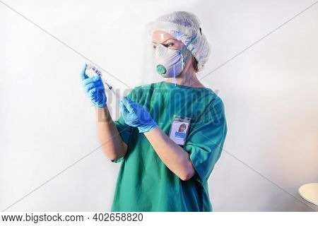 Doctor In Protective Gear Respiratory Mask And Eye Mask In Medical Latex Gloves Draws A Medicinal Fl