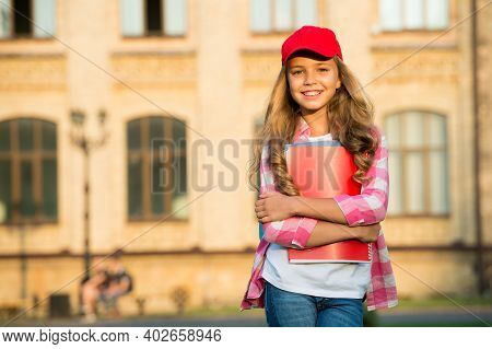 Non-formal Education. Happy Child Hold Books In Schoolyard. School Library. Casual Fashion Style. No