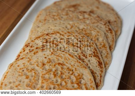 A Close Up Of Derbyshire Oatcakes On A White Platter