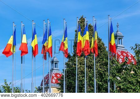 Cluj-napoca, Transylvania, Romania - September 20, 2020: Romanian Flags And Roofs Of The Old Buildin