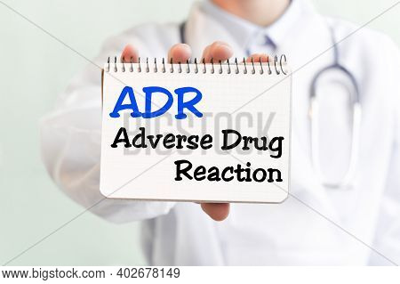 Doctor Holding A Card With Text Adr - Short For Adverse Drug Reaction, Medical Concept. The Text Is 